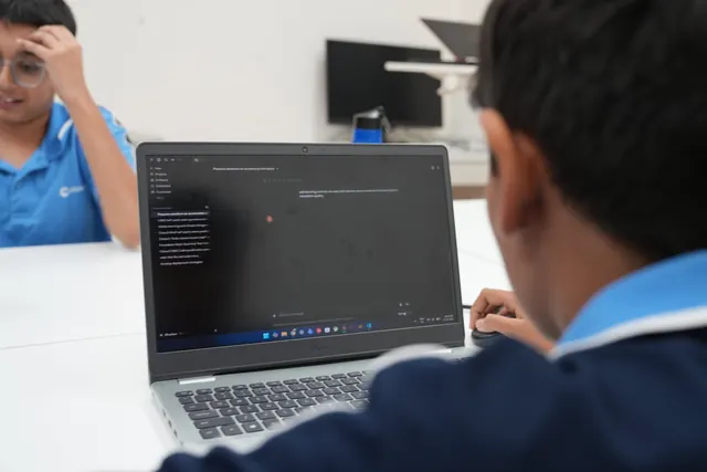 A student uses an AI chat interface on a laptop during the workshop.